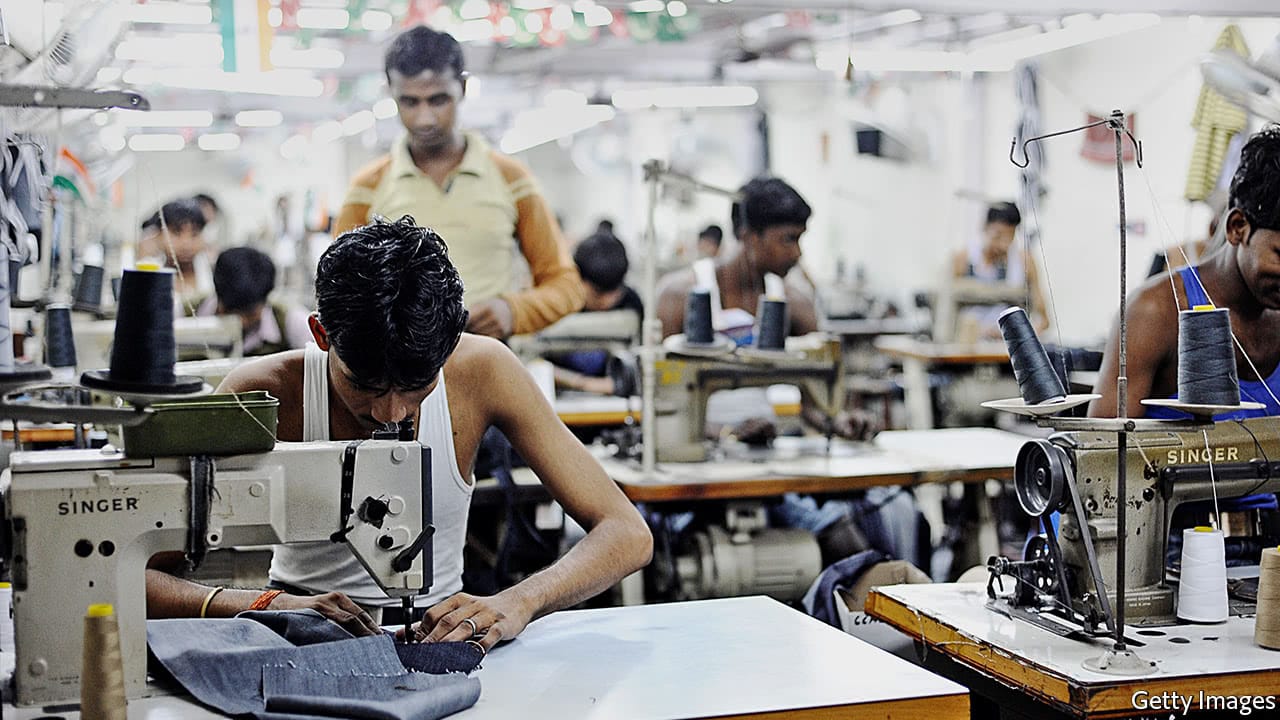 Apparel production line with garments being sewn in a bright manufacturing facility